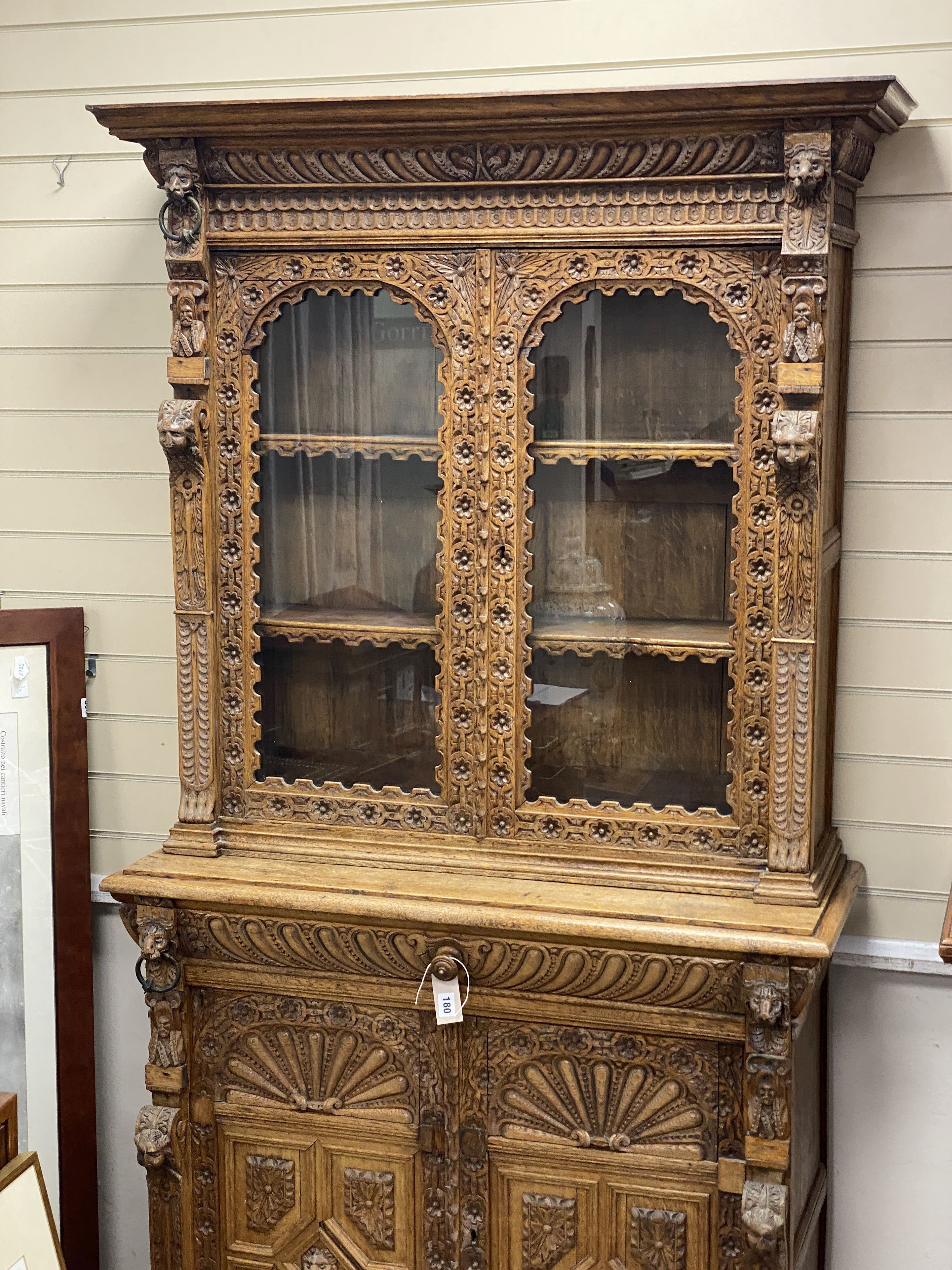 A late 19th century Flemish carved oak bookcase cupboard, width 102cm, depth 43cm, height 206cm